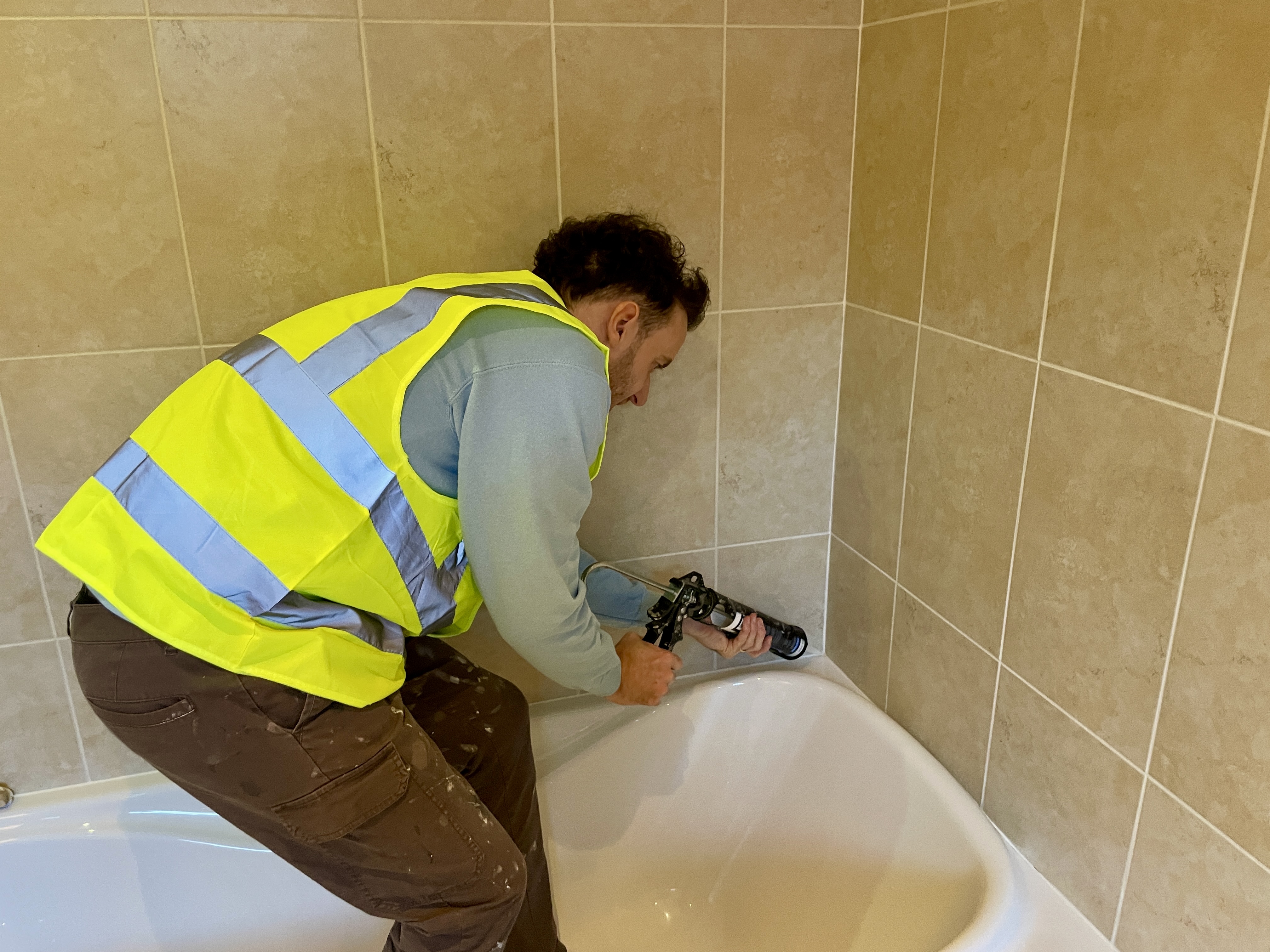 Mastic man applying external sealant to windows in Burnham-On-Crouch